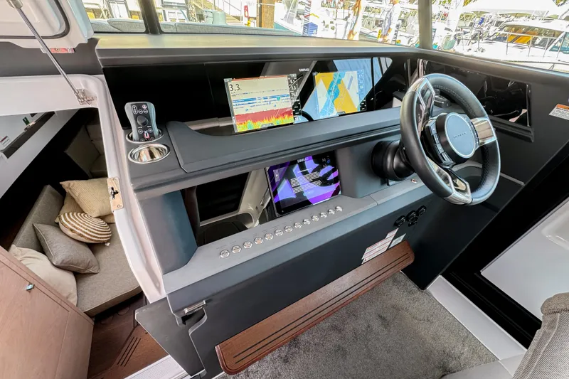 Slide: The Image of 2024 Axopar 45 XC Cross Cabin interior with modern dashboard and navigation displays. - 18