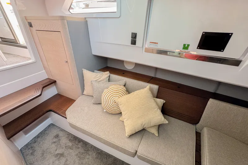 Slide: The Image of 2024 Axopar 45 XC Cross Cabin interior with cozy seating and cushions. - 21