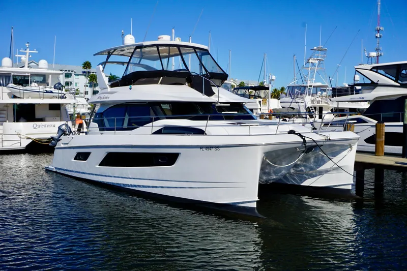 The Image of Aquila 44 Yacht 2020 docked in a marina under clear blue skies. - 1