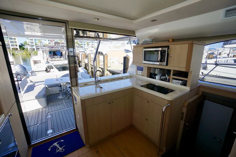 Slide: The Image of Interior of 2020 Aquila 44 Yacht with modern kitchen and outdoor seating area. - 16