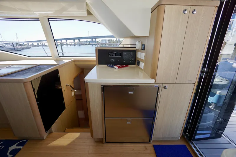 Slide: The Image of Interior of 2020 Aquila 44 Yacht featuring modern kitchen and scenic window view. - 22