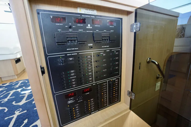Slide: The Image of Electrical control panel inside 2020 Aquila 44 Yacht, showcasing system voltages and switches. - 23