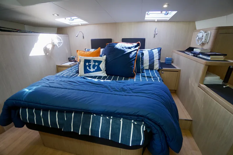 Slide: The Image of Luxurious bedroom interior of 2020 Aquila 44 Yacht with nautical-themed bedding. - 24