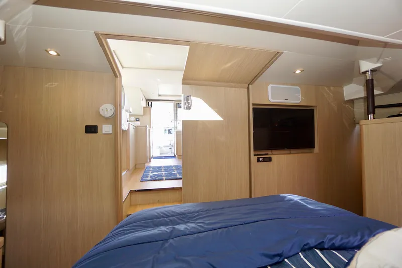 Slide: The Image of Interior of 2020 Aquila 44 Yacht with modern wood finish and cozy bedding. - 26