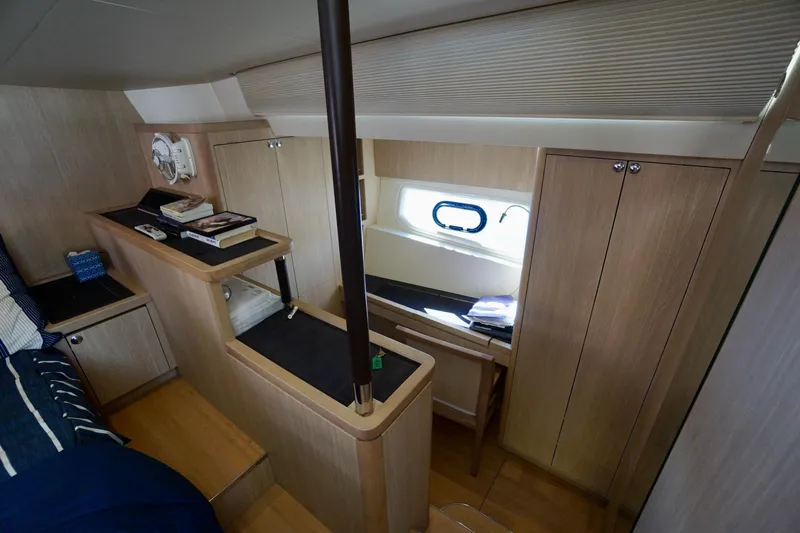 Slide: The Image of 2020 Aquila 44 Yacht interior cabin with wooden furnishings and window. - 27
