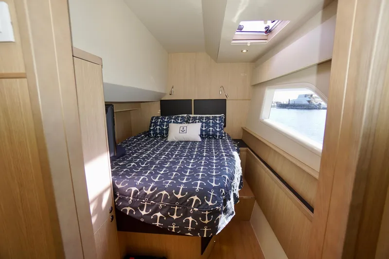 Slide: The Image of Cozy bedroom in 2020 Aquila 44 Yacht with nautical-themed bedding and window view. - 30