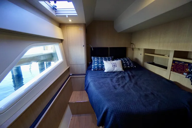 Slide: The Image of Luxurious cabin interior of 2020 Aquila 44 Yacht with nautical-themed bedding. - 32