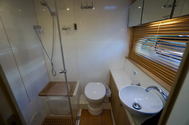 Slide: The Image of Modern bathroom in 2020 Aquila 44 Yacht with shower, toilet, and sink. - 33