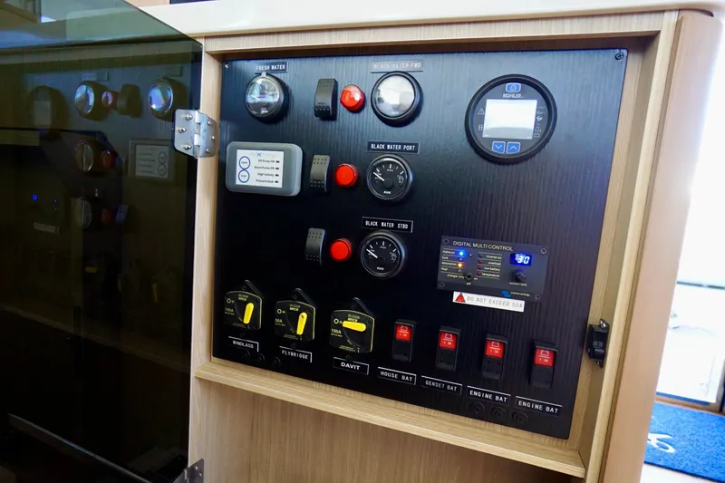 Slide: The Image of Control panel of 2020 Aquila 44 Yacht, featuring gauges and switches for water and power systems. - 34