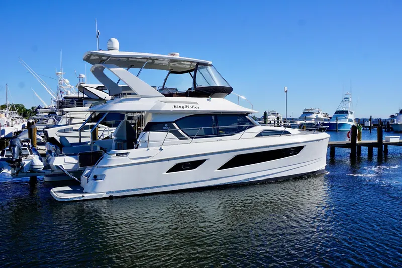 Slide: The Image of Aquila 44 Yacht 2020 docked at marina under clear blue sky. - 4