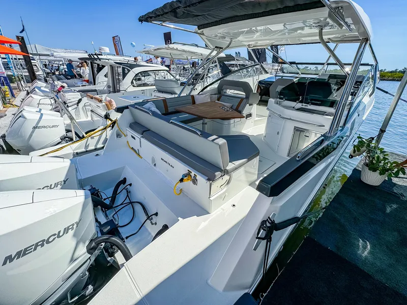 Slide: The Image of 2024 Beneteau Flyer 10 boat with Mercury engines, docked at a marina. - 4