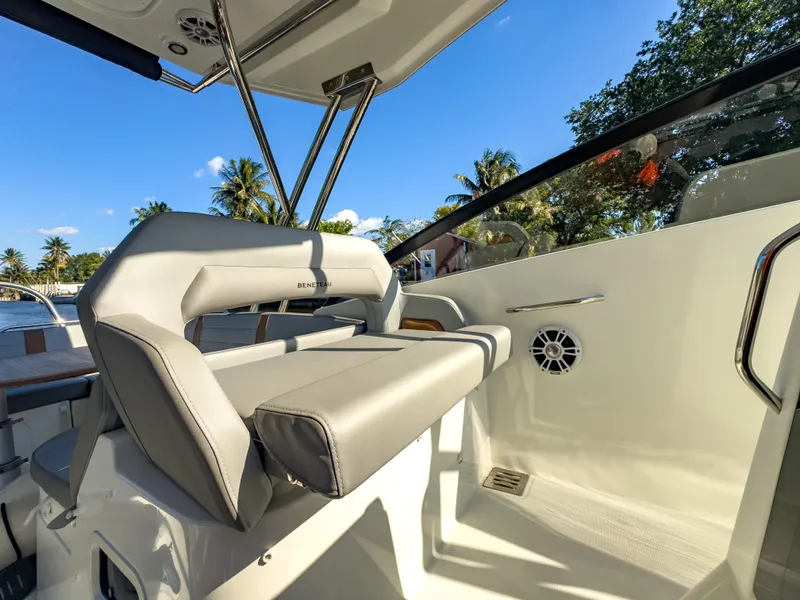 Slide: The Image of 2024 Beneteau Flyer 10 cockpit with modern seating and tropical backdrop. - 8