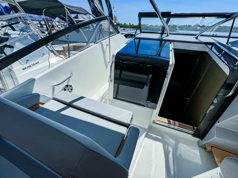 Slide: The Image of 2024 Beneteau Flyer 10 boat interior with seating and helm, showcasing modern design. - 9