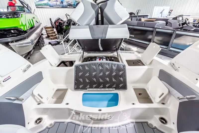 Slide: The Image of 2026 Chaparral 21 SSi boat interior with open storage compartments and seating. - 17