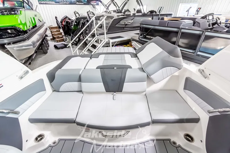 Slide: The Image of 2026 Chaparral 21 SSi boat interior with gray and white seating in showroom. - 19