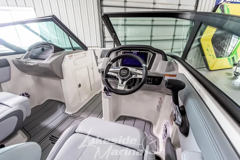 Slide: The Image of 2026 Chaparral 21 SSi boat interior with modern dashboard and steering wheel. - 22