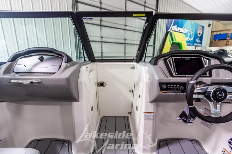 Slide: The Image of Interior view of 2026 Chaparral 21 SSi boat, featuring modern dashboard and steering wheel. - 27