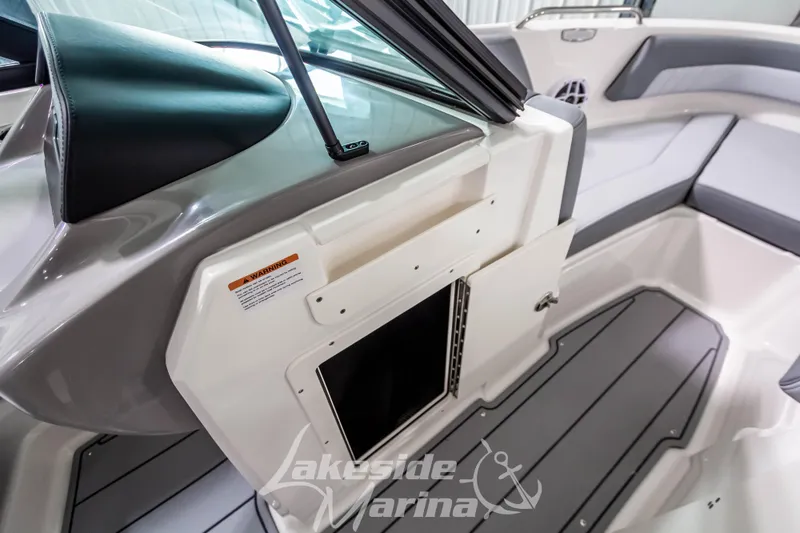 Slide: The Image of 2026 Chaparral 21 SSi boat interior with seating and storage compartment, Lakeside Marina branding. - 29