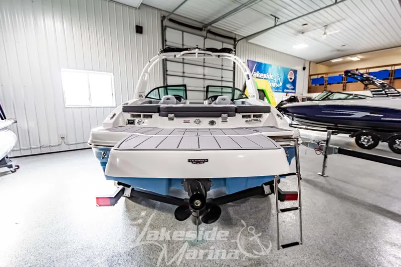 Slide: The Image of 2026 Chaparral 21 SSi boat displayed in a showroom with sleek design and modern features. - 5