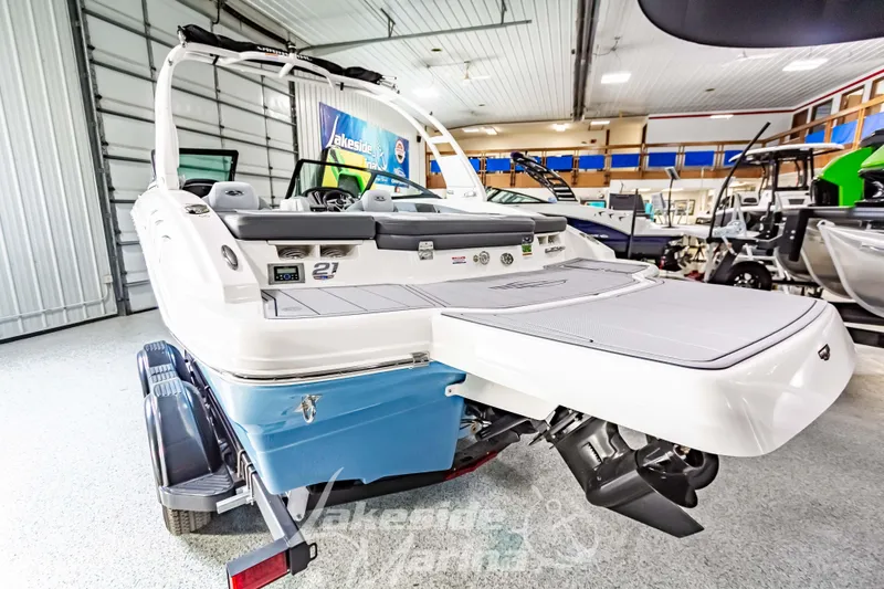 Slide: The Image of 2026 Chaparral 21 SSi boat in showroom, rear view with swim platform. - 6
