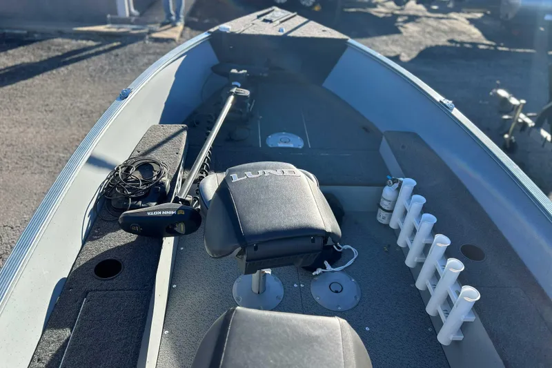 Slide: The Image of 2024 Lund 1600 Fury Tiller boat interior with seating and fishing rod holders. - 10