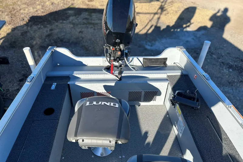 Slide: The Image of 2024 Lund 1600 Fury Tiller boat interior with motor and seating. - 8