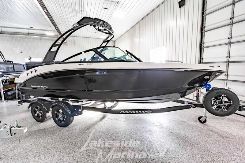 The Image of 2026 Chaparral 21 SSi boat on trailer in indoor showroom. - 1