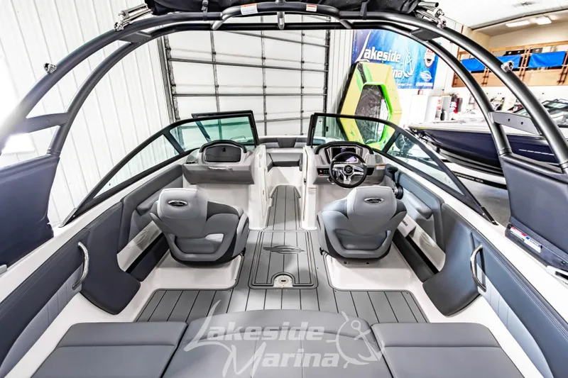 Slide: The Image of 2026 Chaparral 21 SSi boat interior with sleek seating and modern dashboard at Lakeside Marina. - 10