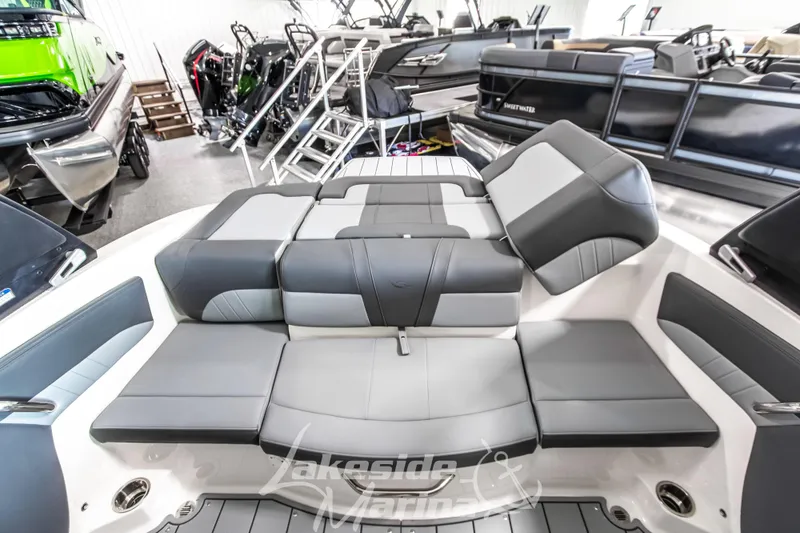 Slide: The Image of 2026 Chaparral 21 SSi boat interior with gray seating in showroom. - 15