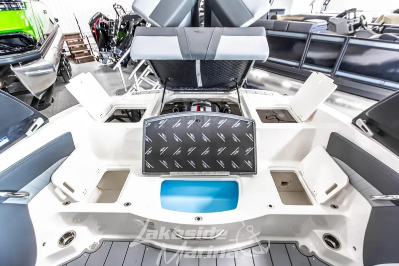 Slide: The Image of 2026 Chaparral 21 SSi boat interior with open storage compartments and engine view. - 17