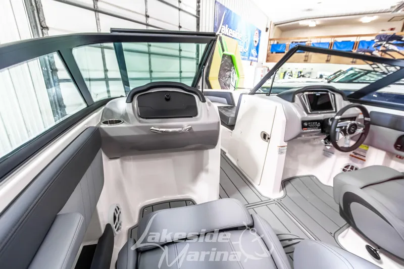 Slide: The Image of 2026 Chaparral 21 SSi boat interior with modern dashboard and seating at Lakeside Marina. - 23