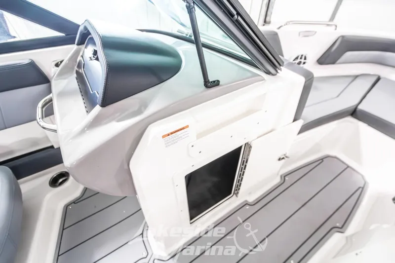 Slide: The Image of 2026 Chaparral 21 SSi boat interior with sleek seating and modern dashboard design. - 27