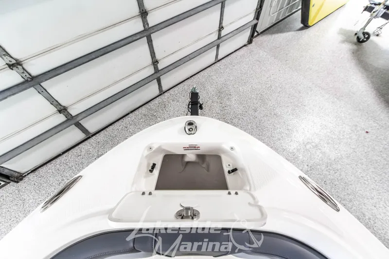 Slide: The Image of 2026 Chaparral 21 SSi boat interior with open storage compartment in a garage setting. - 31