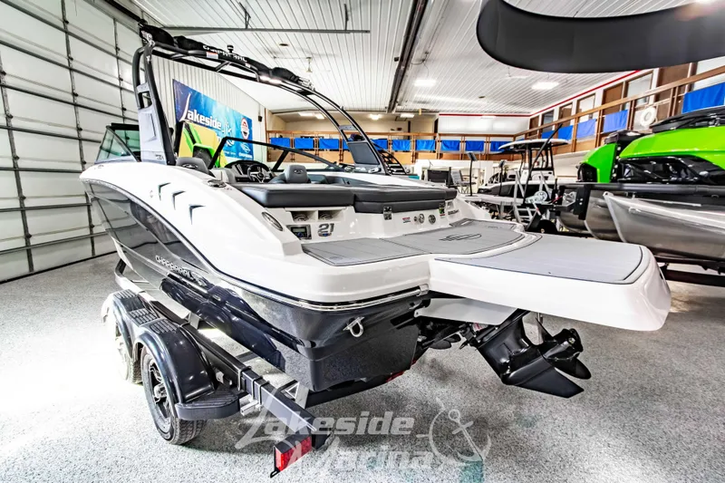 Slide: The Image of 2026 Chaparral 21 SSi boat displayed indoors on a trailer. - 5