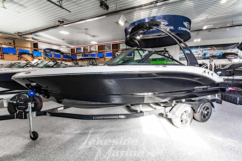 Slide: The Image of 2026 Chaparral 21 SSi boat displayed indoors on a trailer. - 7