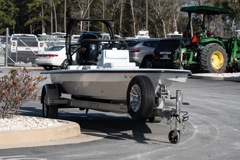 Slide: The Image of 2025 Chittum Skiffs 18 Islamorada boat on trailer in parking lot. - 10