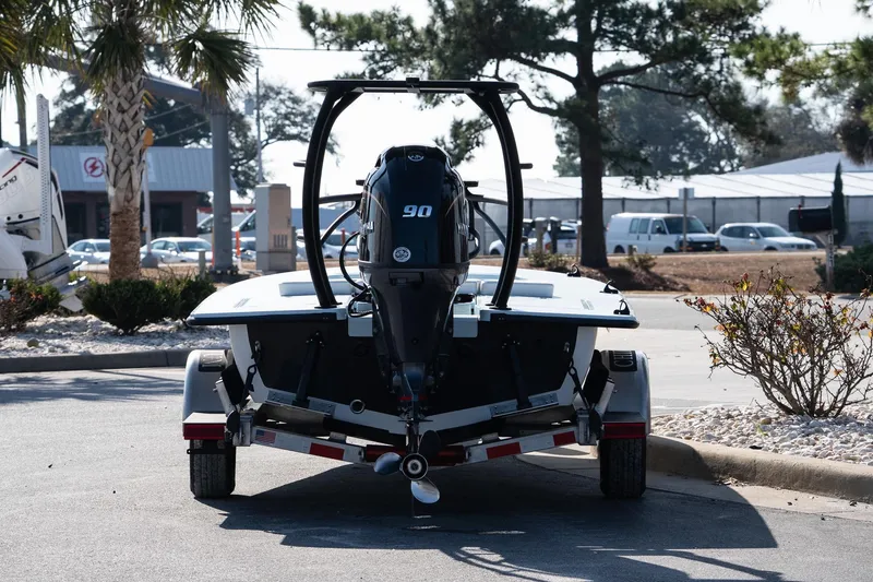 Slide: The Image of 2025 Chittum Skiffs 18 Islamorada boat on trailer, rear view in outdoor setting. - 12