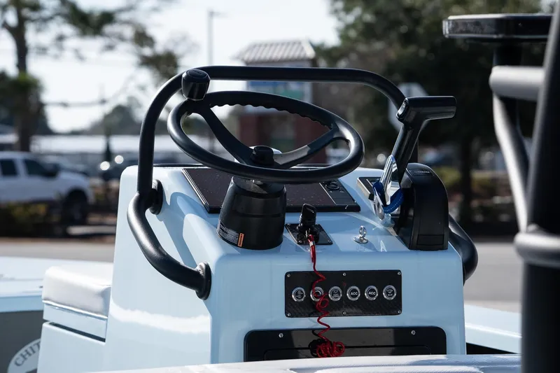 Slide: The Image of 2025 Chittum Skiffs 18 Islamorada boat console with steering wheel and controls. - 13