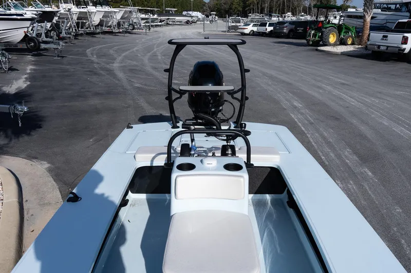 Slide: The Image of 2025 Chittum Skiffs 18 Islamorada boat in a marina parking lot. - 16