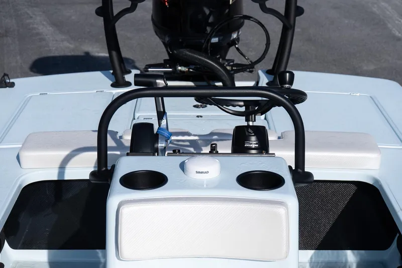 Slide: The Image of 2025 Chittum Skiffs 18 Islamorada boat console with steering wheel and controls. - 17