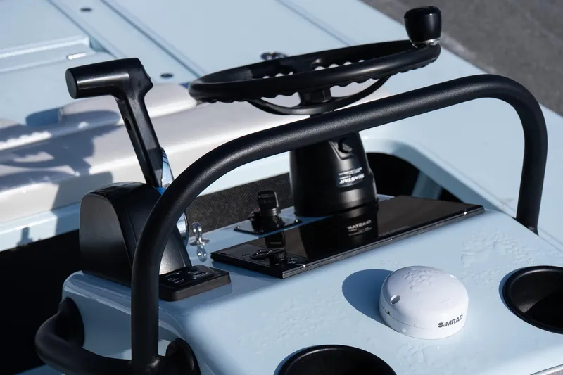 Slide: The Image of 2025 Chittum Skiffs 18 Islamorada boat console with steering wheel and controls. - 18