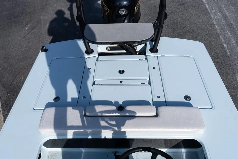 Slide: The Image of 2025 Chittum Skiffs 18 Islamorada boat deck with storage compartments and motor. - 19