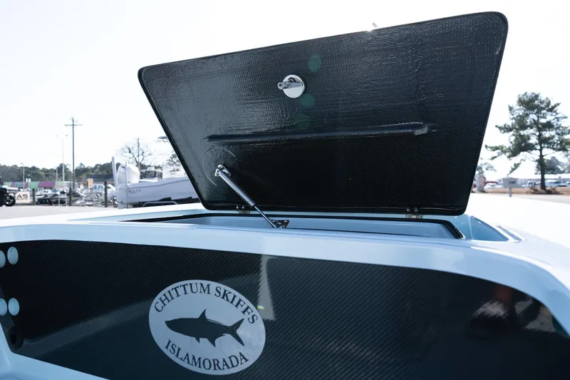 Slide: The Image of 2025 Chittum Skiffs 18 Islamorada boat with open storage compartment. - 21