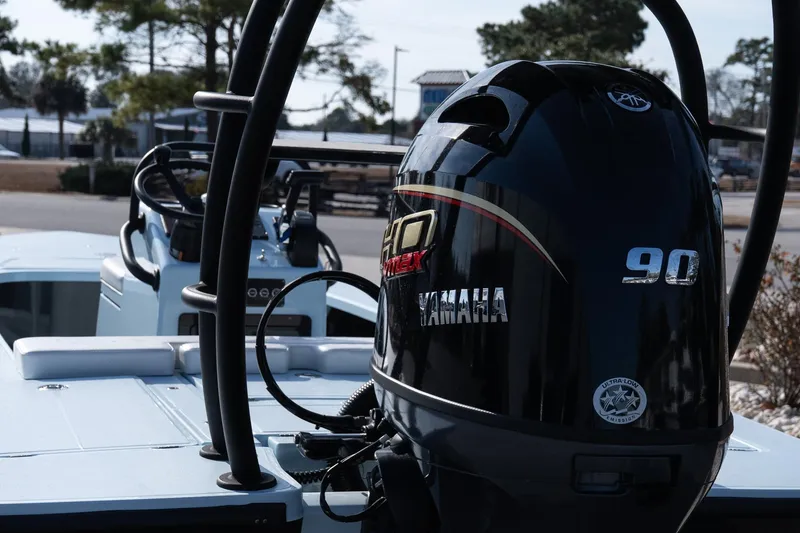 Slide: The Image of 2025 Chittum Skiffs 18 Islamorada with Yamaha 90 outboard engine in a marina setting. - 24