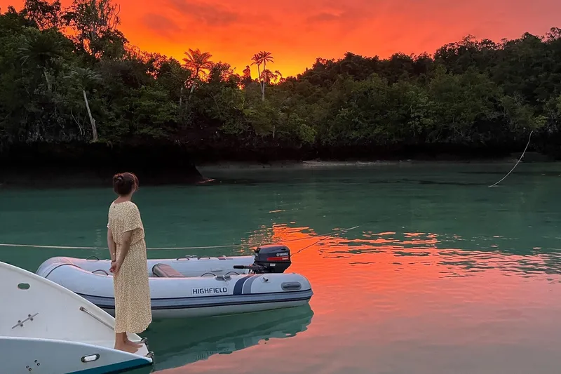 Slide: The Image of Woman stands beside Highfield UltraLite 290LT boat at sunset. - 3