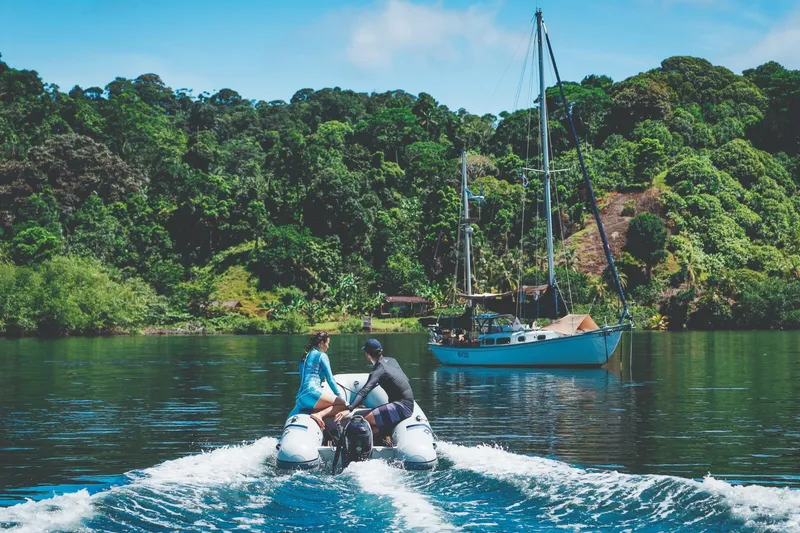 Slide: The Image of Two people on a 2026 Highfield UltraLite 290LT boat in tropical setting. - 2