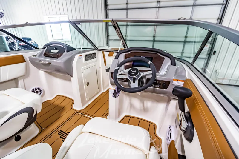 Slide: The Image of 2026 Chaparral 21 SSi boat interior with luxurious seating at Lakeside Marina showroom. - 18
