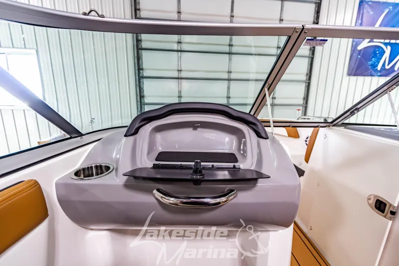 Slide: The Image of 2026 Chaparral 21 SSi boat interior with modern dashboard and seating. - 21