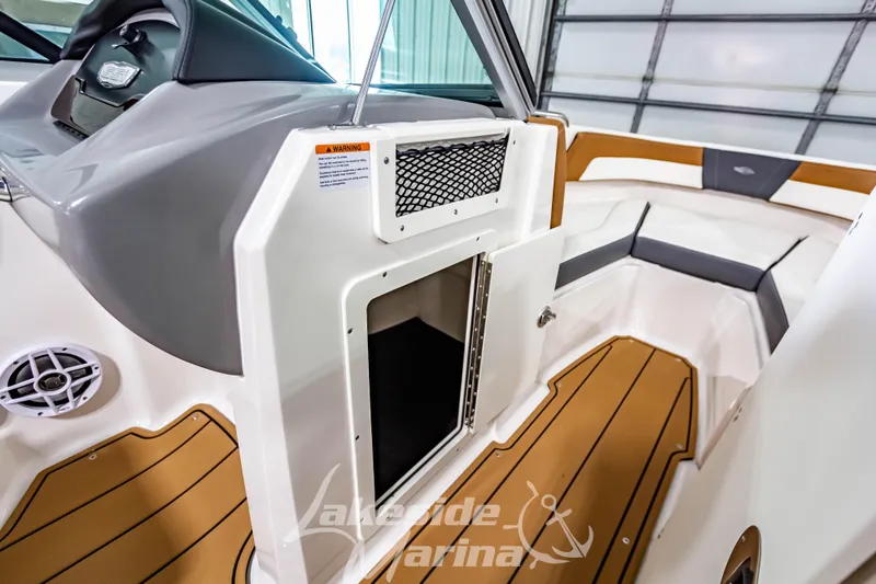 Slide: The Image of 2026 Chaparral 21 SSi boat dashboard with cup holder and storage compartment. - 24