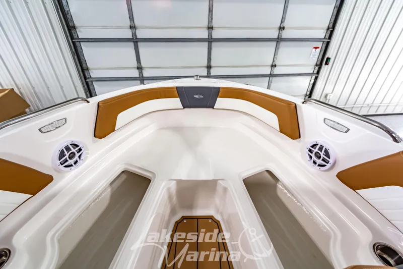 Slide: The Image of 2026 Chaparral 21 SSi boat interior with open storage compartment and modern dashboard. - 26